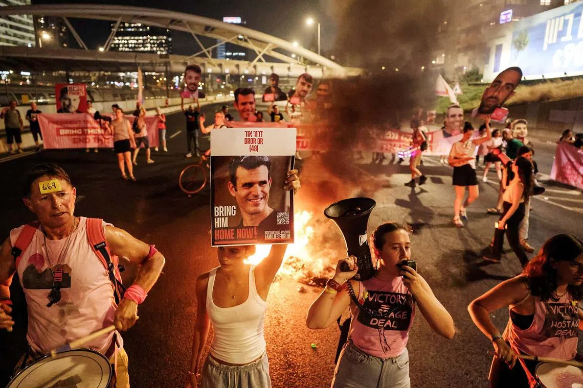 A fire burns as demonstrators and relatives of hostages block a road demanding the immediate release of hostages who were kidnapped during the deadly Oct 7 attack on Israel by Hamas, and the end of the war in Gaza, in Tel Aviv, Israel, Aug 5, 2025. 