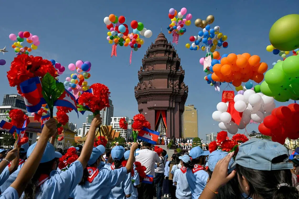 Cambodian students holding up flowers as balloons are released at the Independence Monument, during a ceremony marking Cambodia's 72nd Independence Day, in Phnom Penh on Nov 9, 2025. 