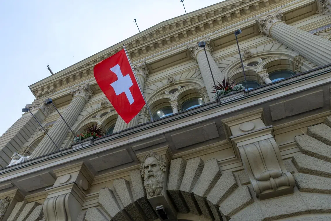 The Swiss flag is seen on the Swiss Parliament house (Bundeshaus) in Bern, Switzerland, June 15, 2023.  REUTERS/Denis Balibouse/File Photo