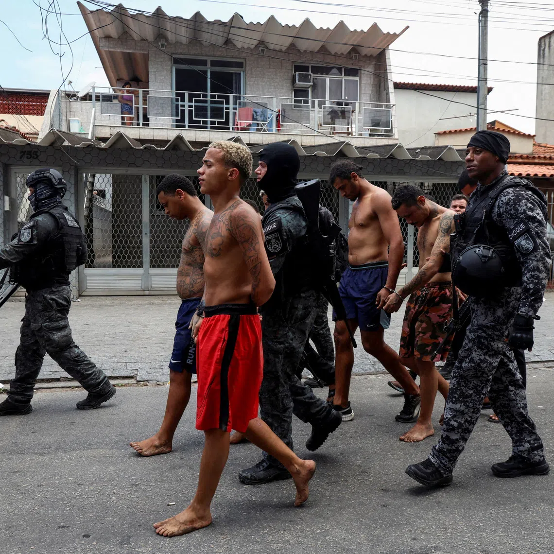 FILE PHOTO: Members of the military police special unit detain suspected drug dealers during a police operation against drug trafficking at a favela in the Penha slum complex, in Rio de Janeiro, Brazil October 28, 2025. REUTERS/Aline Massuca/File Photo