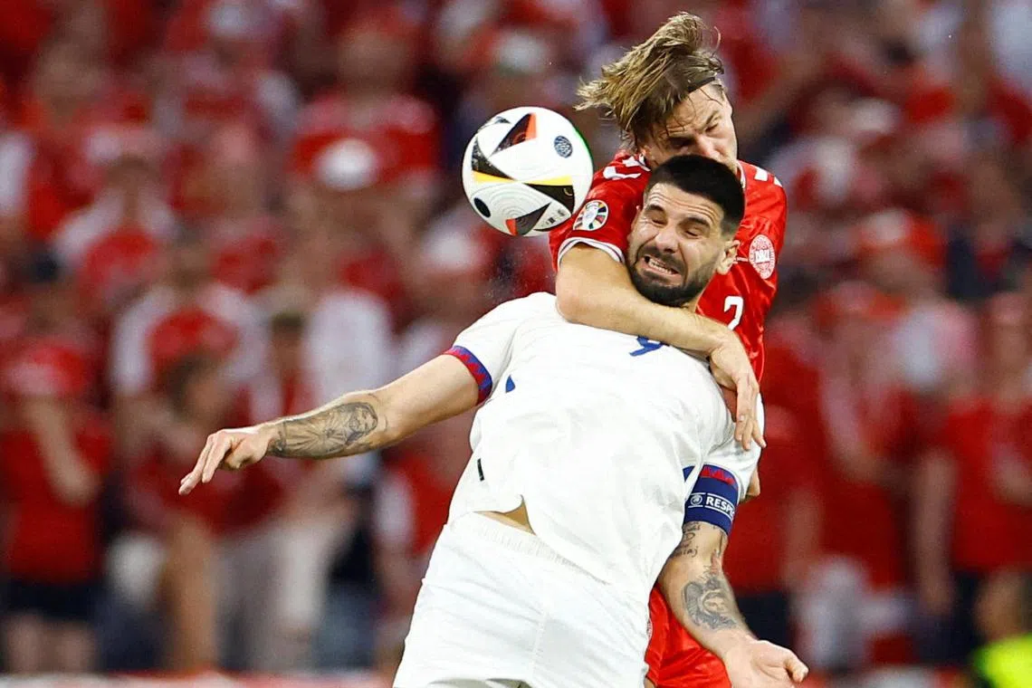 Serbia's Aleksandar Mitrovic in action with Denmark's Joachim Andersen.