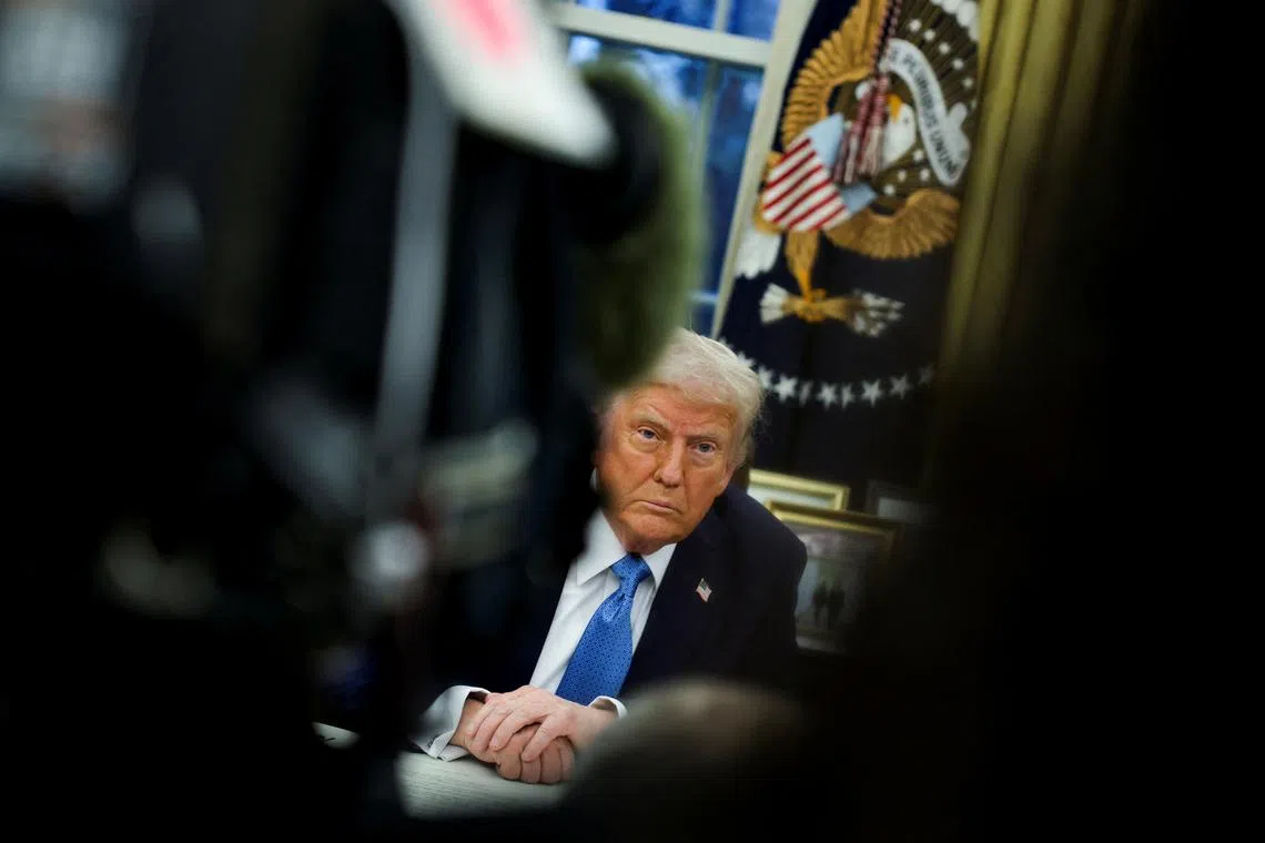 U.S. President Donald Trump looks on as he signs an executive order in the Oval Office at the White House in Washington, U.S., January 31, 2025. REUTERS/Carlos Barria