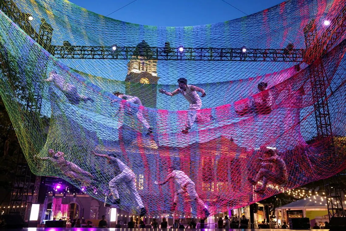 Performers suspended above the ground inside a giant aerial net during a rehearsal for Noli Timere at Empress Lawn, Singapore, on May 14, during the media preview of the Singapore International Festival of Arts (SIFA), that will showcase local and international theatre, dance, music and multidisciplinary works from May 15 to 30. 