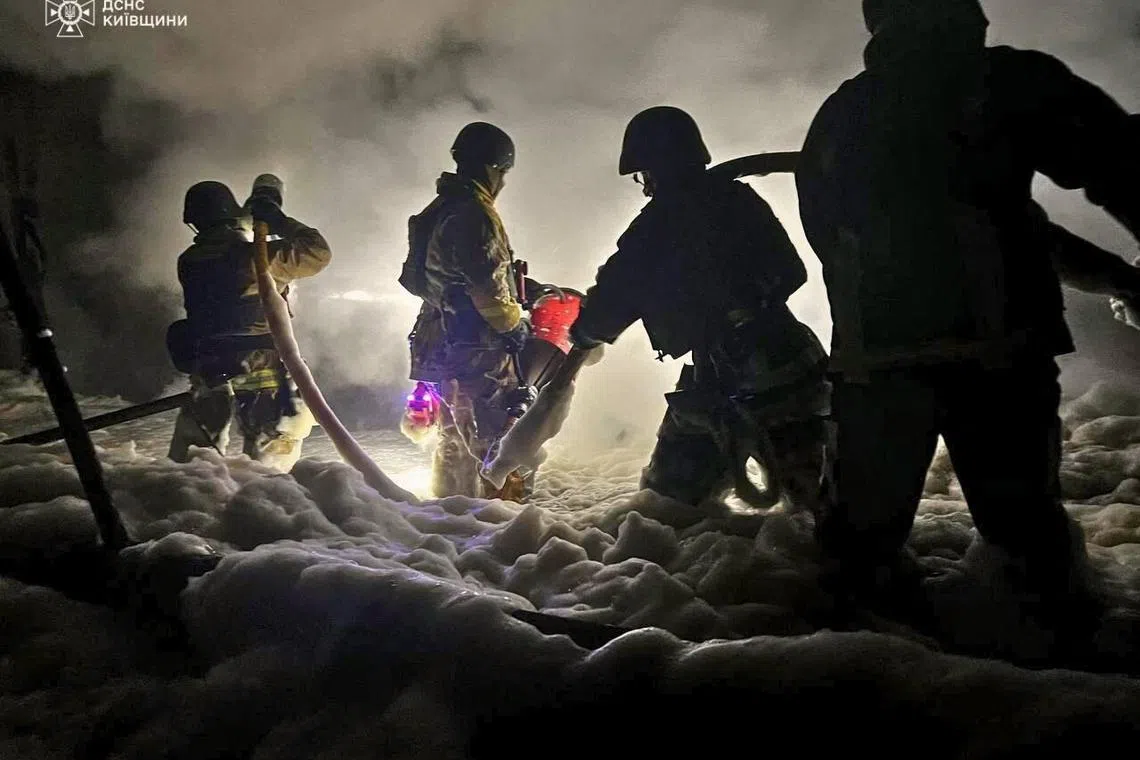 Firefighters putting out a fire at an industrial enterprise in Kyiv region following Russian drone strike, amid the Russian invasion of Ukraine on Sept 8, 2025