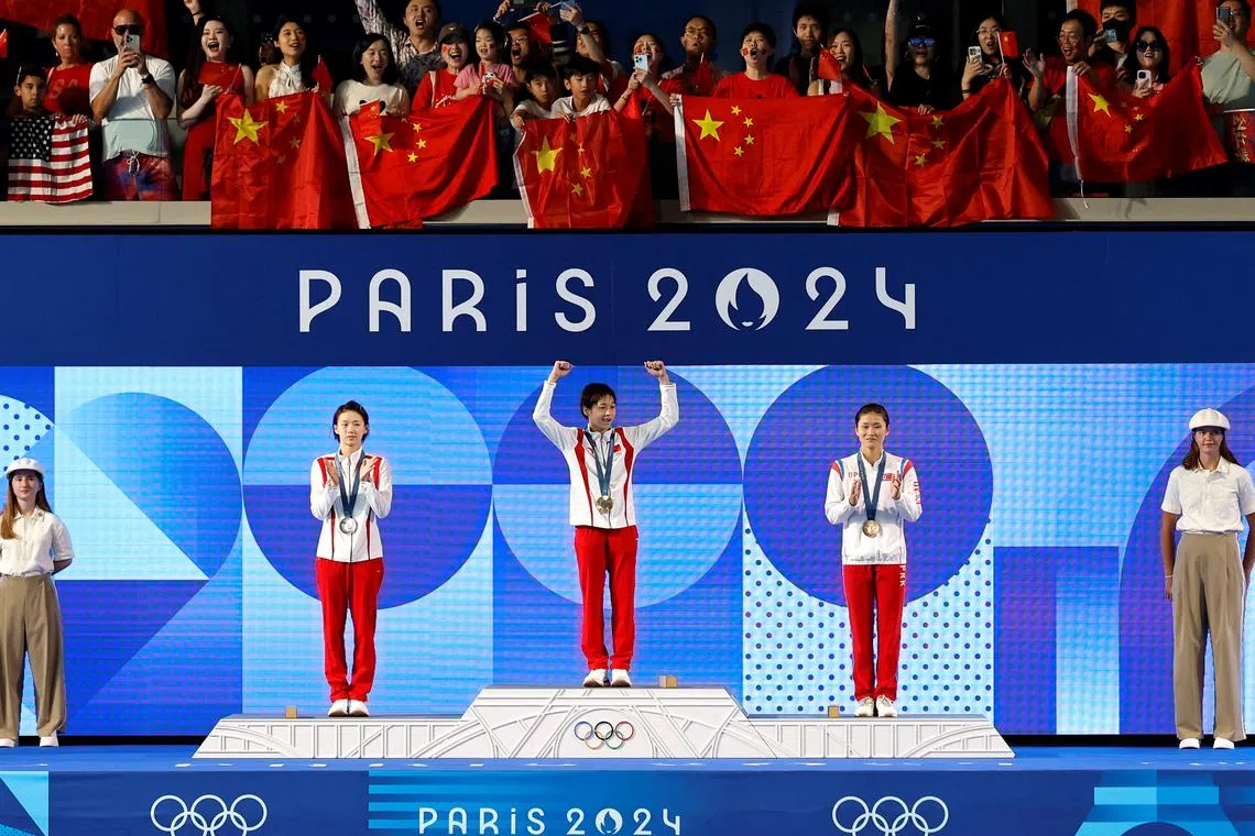 Paris 2024 Olympics - Diving - Women's 10m Platform Victory Ceremony - Aquatics Centre, Saint-Denis, France - August 06, 2024. Gold medallist Hongchan Quan of China celebrates on the podium with silver medallist Yuxi Chen of China and bronze medallist Mi Rae Kim of North Korea. REUTERS/Lisa Leutner/File Photo