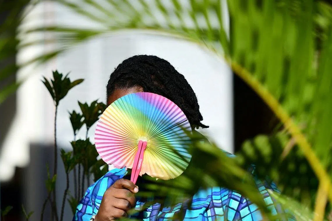 FILE PHOTO: Ashley Karungi 33, a member of the lesbian, gay, bisexual, transgender, intersex and queer (LGBTQ) community and a single mother of two poses for a picture with rainbow colours at the offices of Rella Women's Empowerment Program, for LGBTQ rights advocacy, after a Reuters interview in Kulambiro suburb of Kampala, Uganda April 4, 2023. REUTERS/Abubaker Lubowa/File Photo
