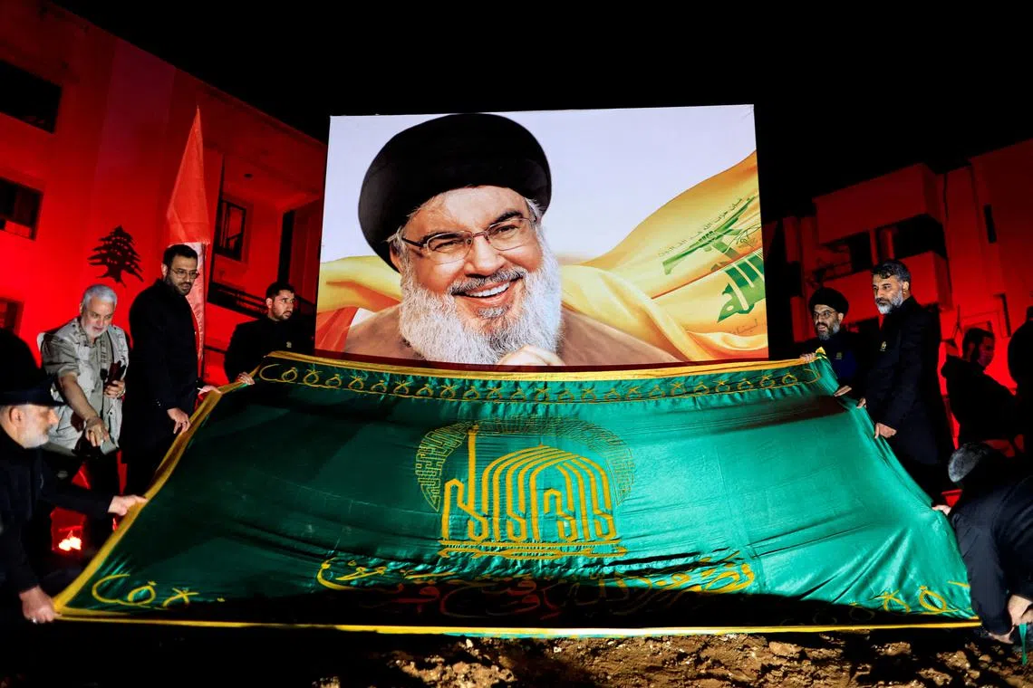 FILE PHOTO: People gather at a site damaged by Israeli airstrike that killed Lebanon's Hezbollah leader Sayyed Hassan Nasrallah during a commemoration ceremony in Beirut southern suburbs, Lebanon November 30, 2024. REUTERS/Thaier Al-Sudani/File Photo