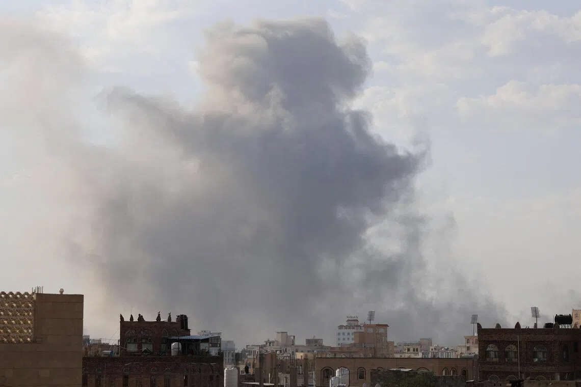 Smoke rising from the sites of Israeli air strikes in Yemen's capital, Sanaa, on Sept 25.