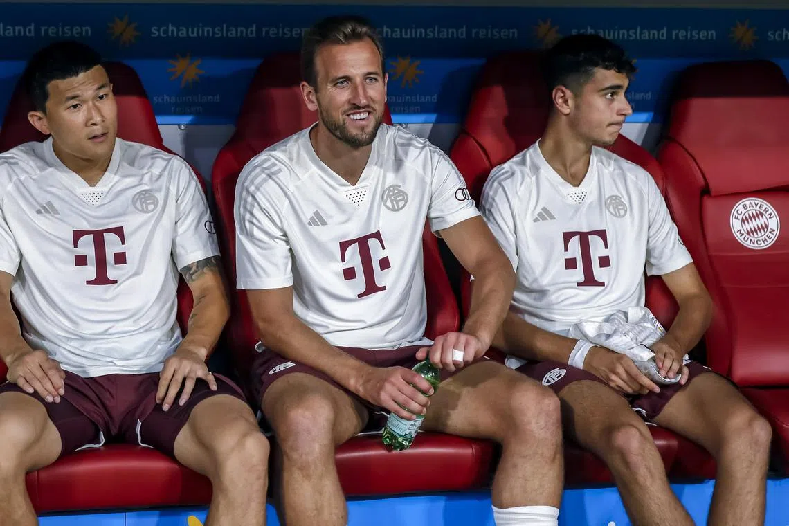 Kane (centre) was named on the Bayern Munich bench for the German Super Cup.