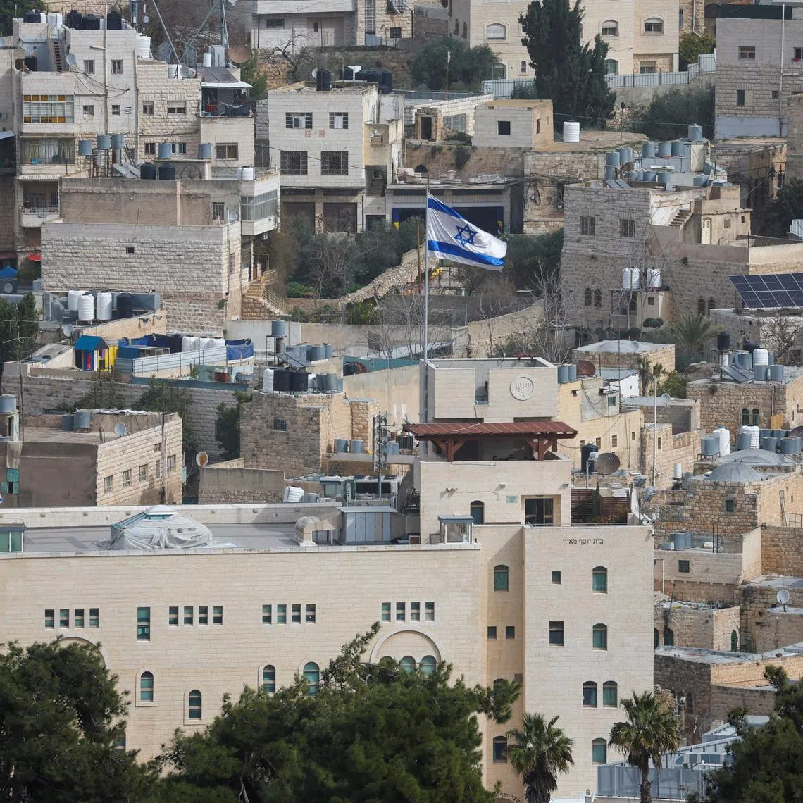 An Israeli flag flies over an Israeli settlement in the old city in Hebron in the Israeli-occupied West Bank, February 9, 2026. REUTERS/Mussa Qawasma