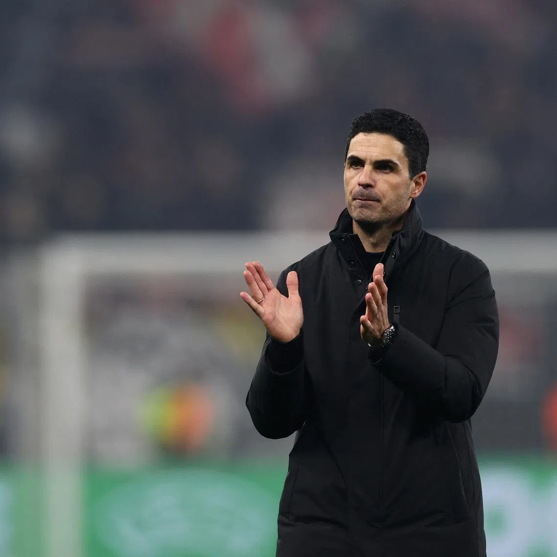 Soccer Football - UEFA Champions League - Round 16 - First Leg - Bayer Leverkusen v Arsenal - BayArena, Leverkusen, Germany - March 11, 2026 Arsenal manager Mikel Arteta applauds fans after the match REUTERS/Wolfgang Rattay