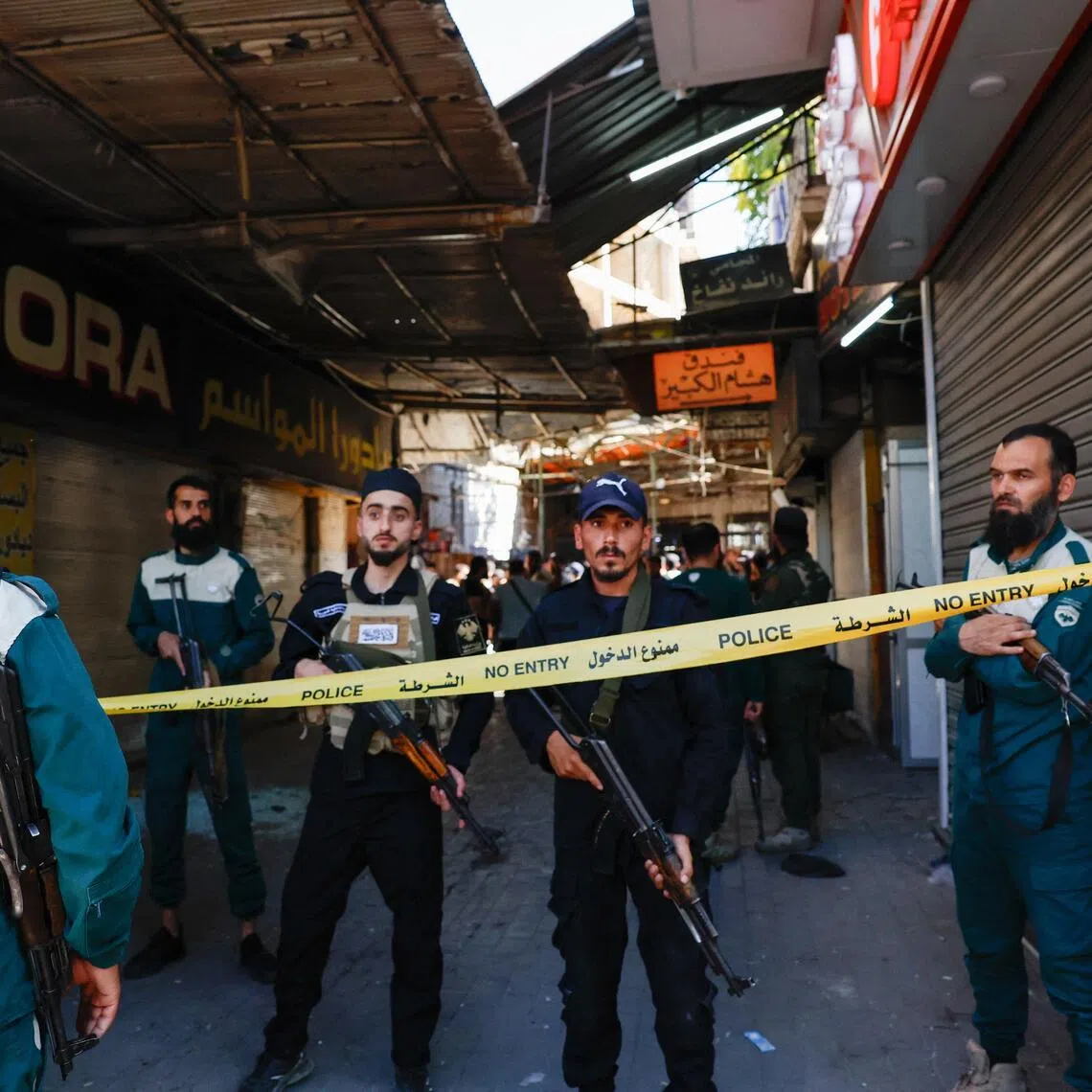 Police officers stand at an area cordoned off with police tape near the site of what Syrian state media reported was a blast at a cafe in central Damascus, Syria, July 2, 2026. REUTERS/Yamaam Al Shaar