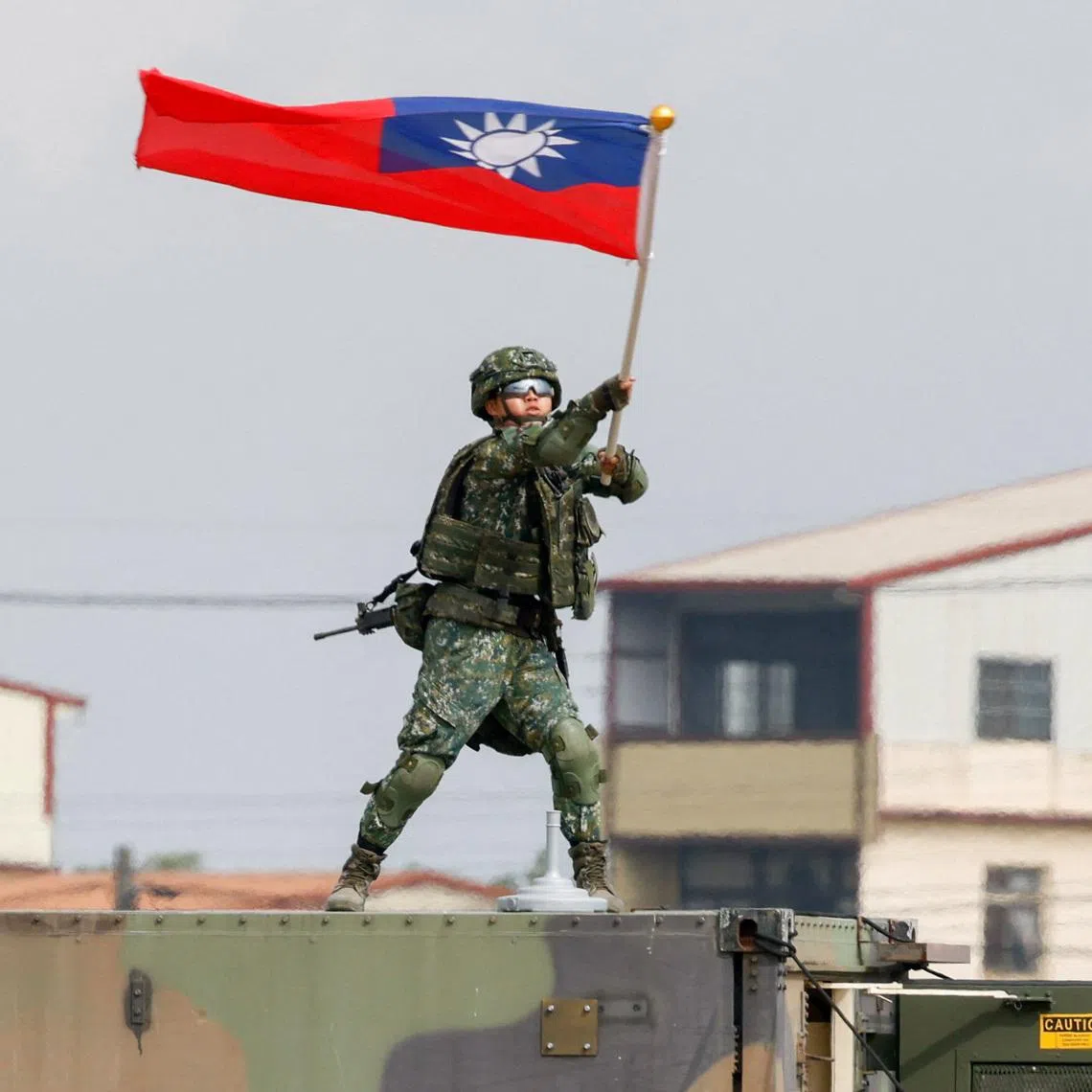A Taiwanese army soldier waves a flag during an annual military exercise ahead of Lunar New Year in Taichung, Taiwan, January 27, 2026. REUTERS/Ann Wang