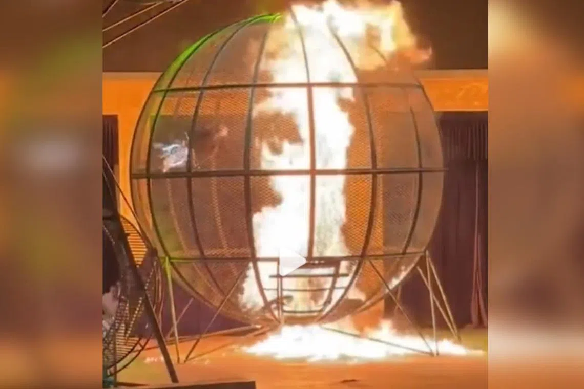 One of the riders appears to lose his grip on the cage’s walls and falls to the bottom of the globe. His bike then bursts into flames.