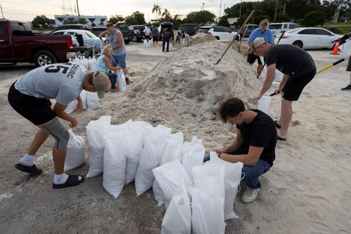 People fill up sandbags at Joe DiMaggio Sports Complex as Tropical Storm Helene intensifies before its expected landfall on Florida's Big Bend, in Clearwater, Florida, U.S. September 25, 2024.  REUTERS/Marco Bello