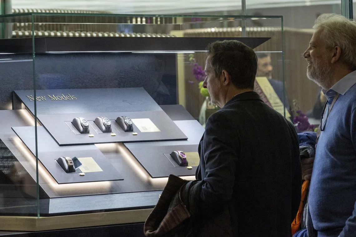 Visitors look at models on the Patek Philippe  booth during the Watches and Wonders fair in Geneva, Switzerland March 27, 2023. REUTERS/Denis Balibouse
