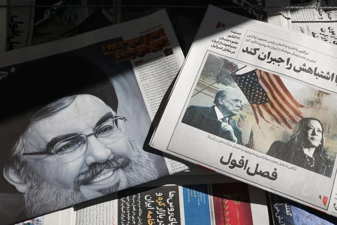 A newspaper with a picture of Republican presidential nominee and former U.S. President Donald Trump and Democratic presidential nominee U.S. Vice President Kamala Harris is seen next to a newspaper with a picture of late Lebanon's Hezbollah leader Sayyed Hassan Nasrallah, in Tehran, Iran November 6, 2024. Majid Asgaripour/WANA (West Asia News Agency) via REUTERS