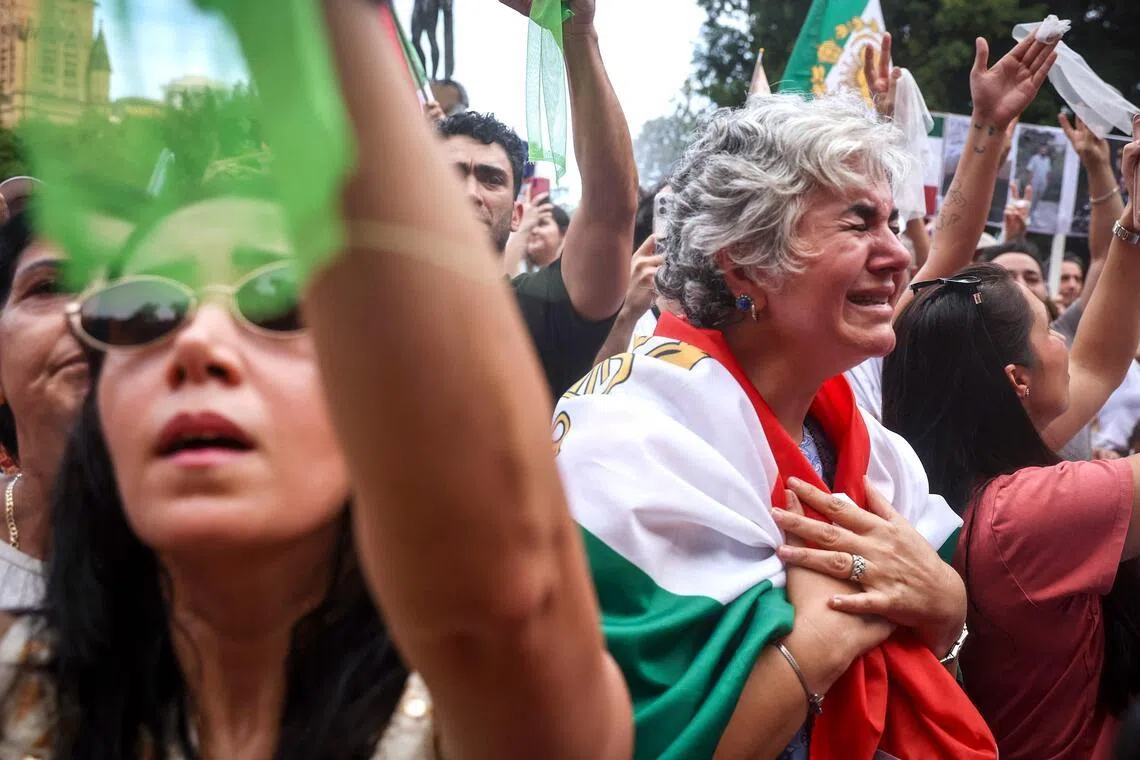 A woman cries as she stands with other members of the Iranian community during a rally in Sydney on March 1.