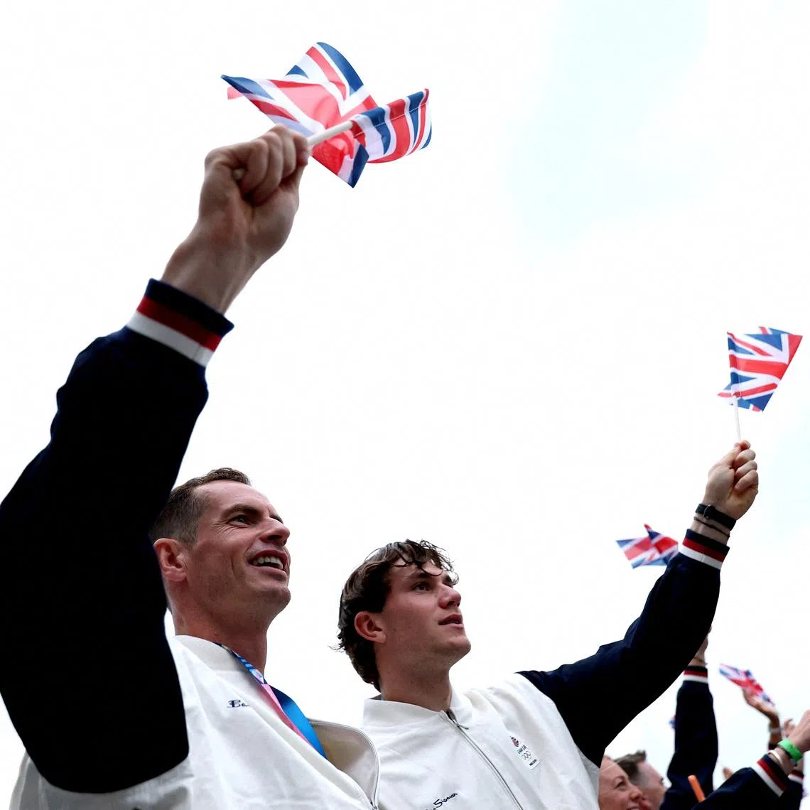 FILE PHOTO: Paris 2024 Olympics - Opening Ceremony - Paris, France - July 26, 2024. Tennis players, Andy Murray and Jack Draper of Britain wave flags on the team boat during the opening ceremony of the Olympic Games Paris 2024.     Naomi Baker/Pool via REUTERS/File Photo