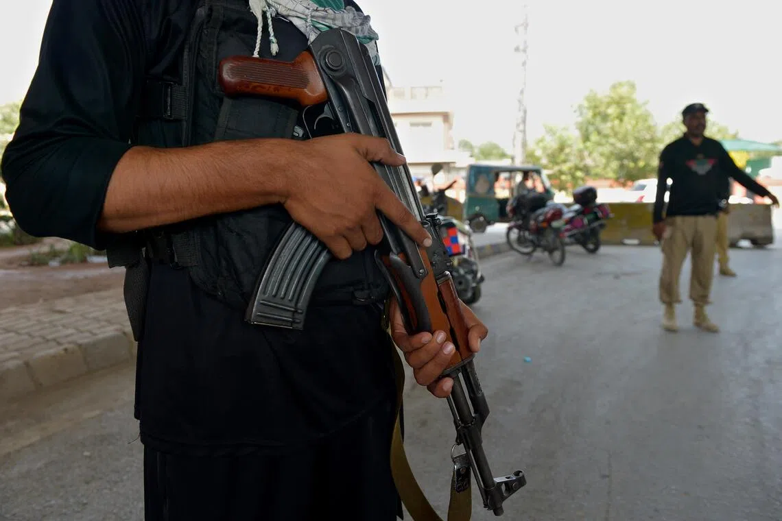 Pakistani security officials stand guard at a checkpoint, as security has been intensified, in Peshawar, Khyber Pakhtunkhwa province, Pakistan, on Sept 22, 2025.