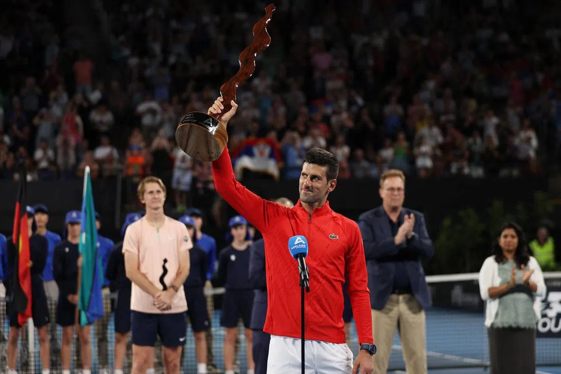 Novak Djokovic celebrates with the trophy after winning the Adelaide International on Sunday.