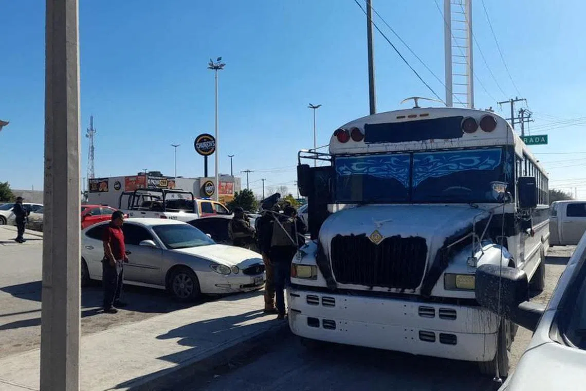 Police authorities stand outside a bus transporting the migrants who were kidnapped, on Jan 3, after they were freed.
