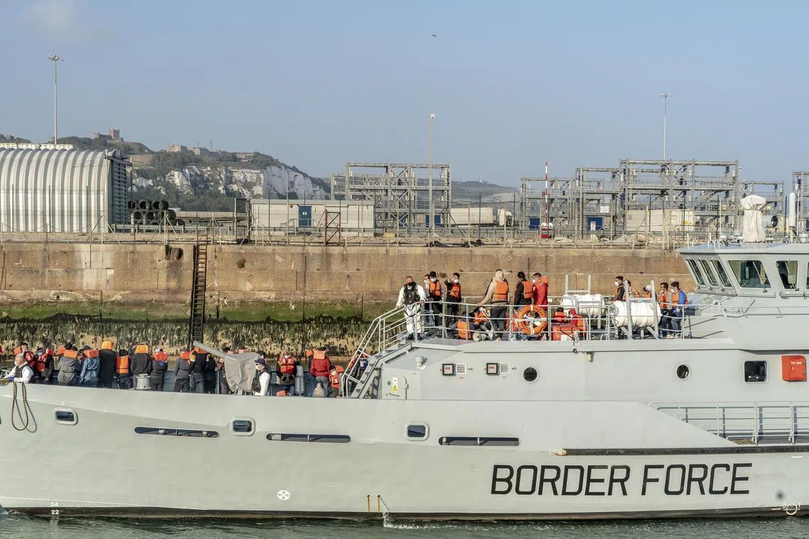 A 2021 photo shows Britain’s Border Force bringing in migrants rescued from the English Channel, in Dover, England.