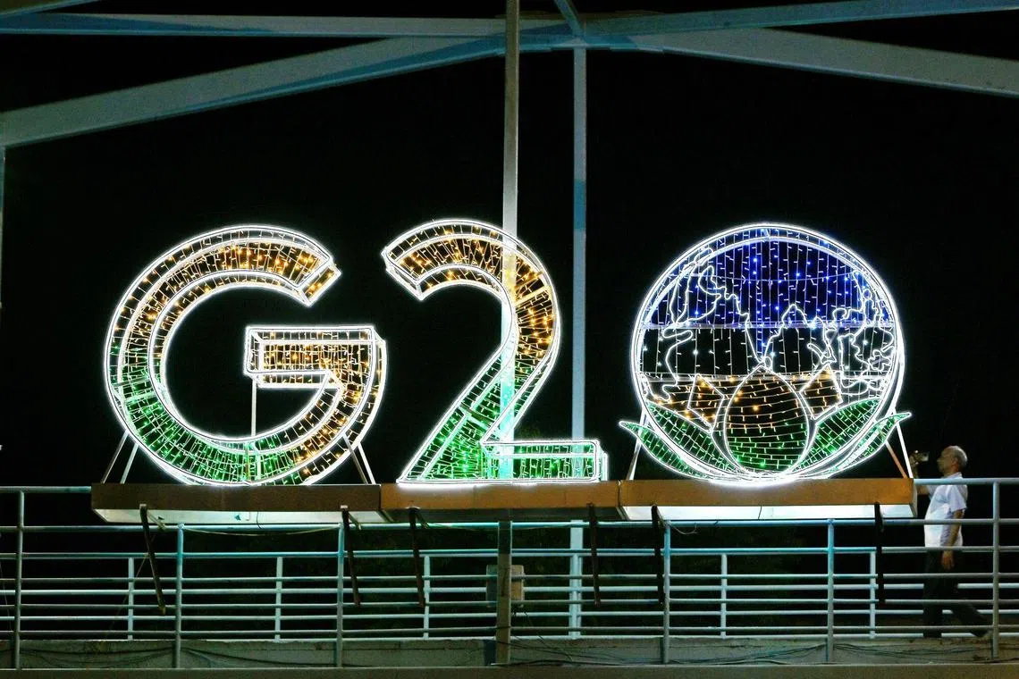 Signage for the Group of 20 (G-20) summit illuminated at night outside the Bharat Mandapam, venue for the summit, in New Delhi, India, on Sunday, Sept. 3, 2023. The G-20 summit is scheduled to run through Sept. 9 to 10 in New Delhi. Photographer: Prakash Singh/Bloomberg