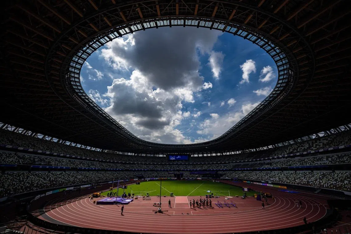 Officials and workers prepare the National Stadium in Tokyo on Sept 11 ahead of the World Athletics Championships. 