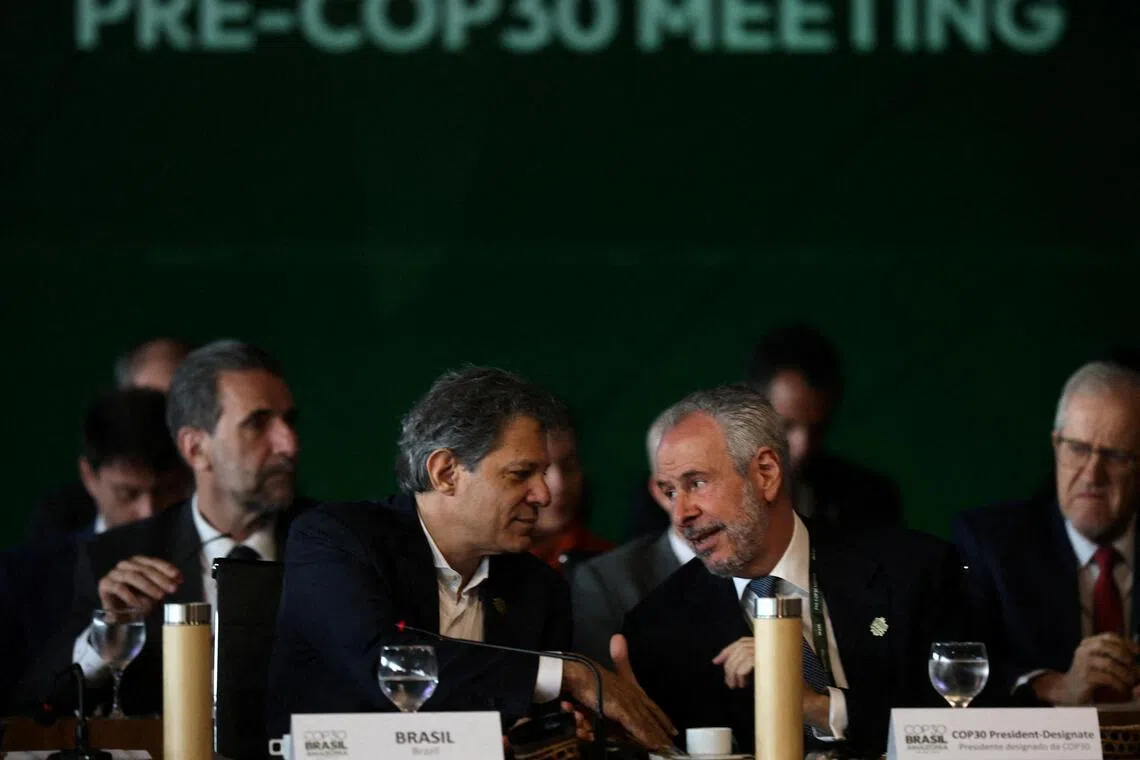 Brazilian Finance Minister Fernando Haddad talking to COP30 president Andre Correa do Lago during the ministerial preparatory meeting (Pre-COP30), ahead of the COP30 Climate Summit, in Brasilia, Brazil October 13, 2025. REUTERS/Mateus Bonomi/File Photo
