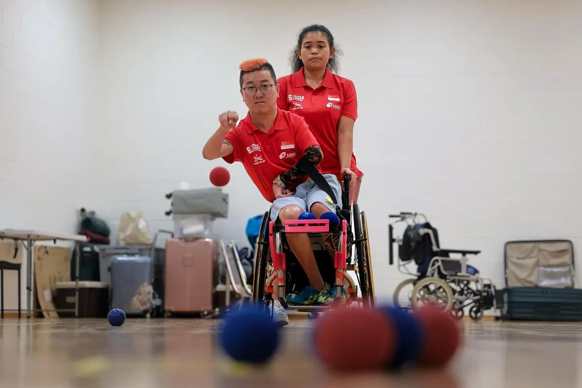 Former Paralympic sailor Jovin Tan training boccia at OCBC Arena on Sep 13, 2025. With him is his caregiver Nuraeni Zian.