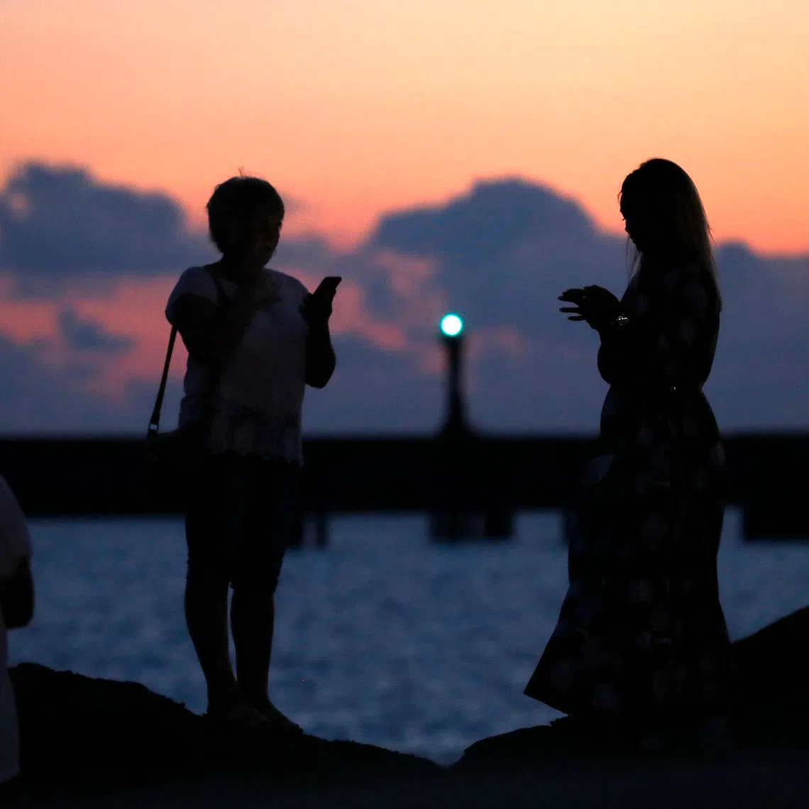 Women look on near the port in Sochi, Russia June 20, 2018. REUTERS/Francois Lenoir