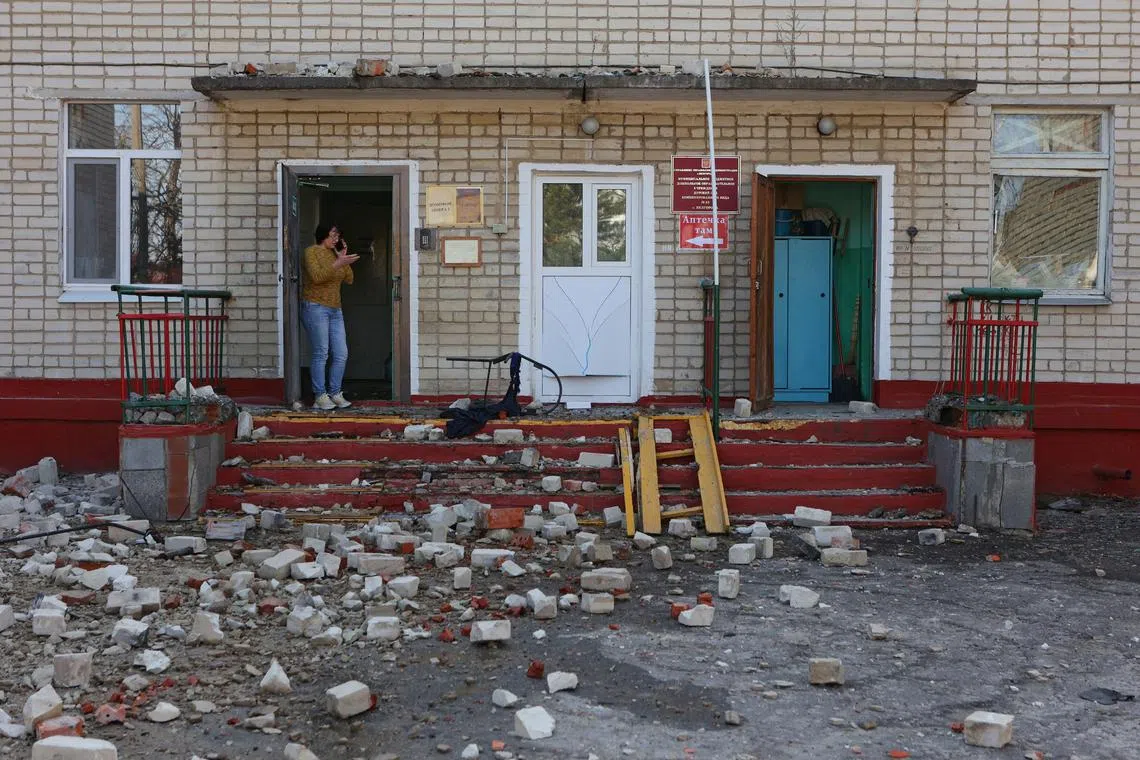 FILE PHOTO: A woman stands at the entrance to a kindergarten building hit by shelling, what local authorities called a Ukrainian military strike, in the course of the Russia-Ukraine conflict in Belgorod, Russia March 20, 2024. REUTERS/Stringer/File Photo