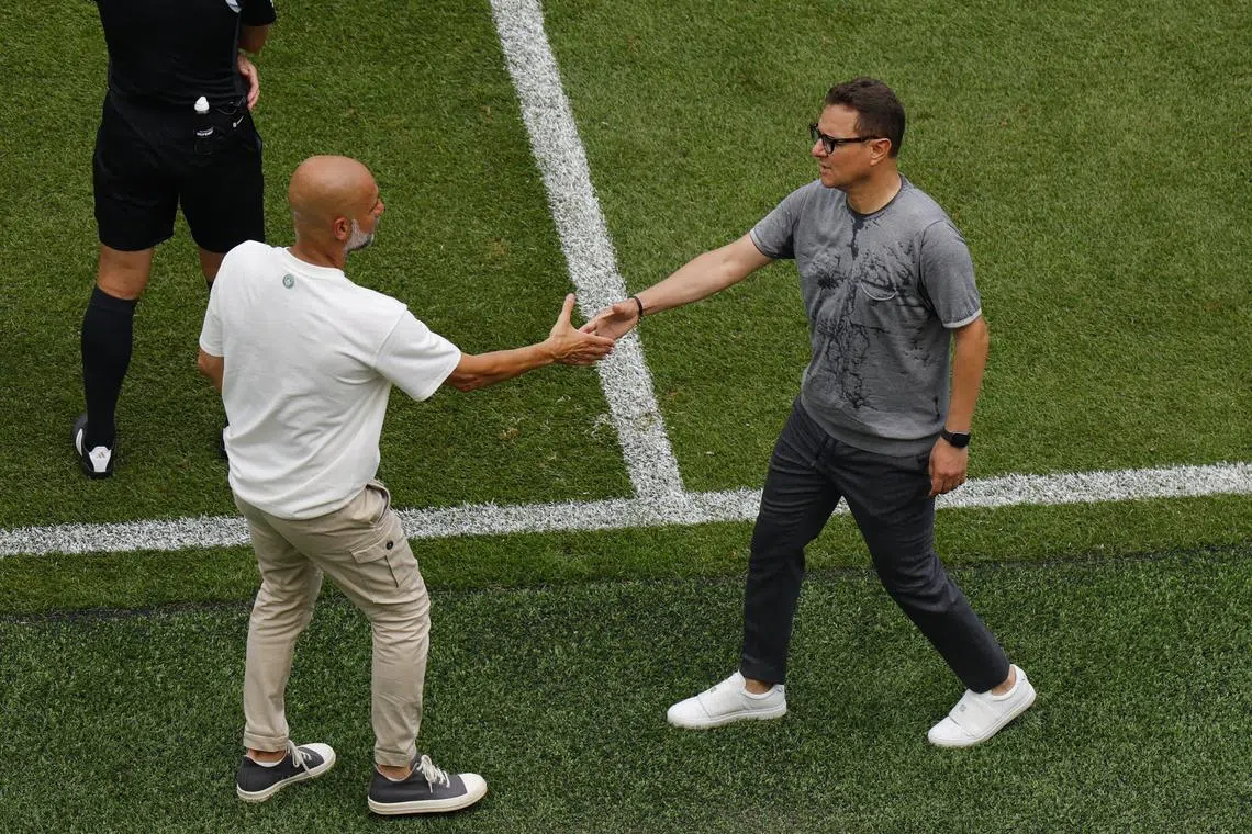 FILE PHOTO: Soccer Football - FIFA Club World Cup - Group G - Manchester City v Wydad Casablanca - Lincoln Financial Field, Philadelphia, Pennsylvania, U.S. - June 18, 2025, Manchester City manager Pep Guardiola shakes hands with Wydad Casablanca coach Mohamed Amine Benhachem after the match REUTERS/Brian Snyder/File Photo