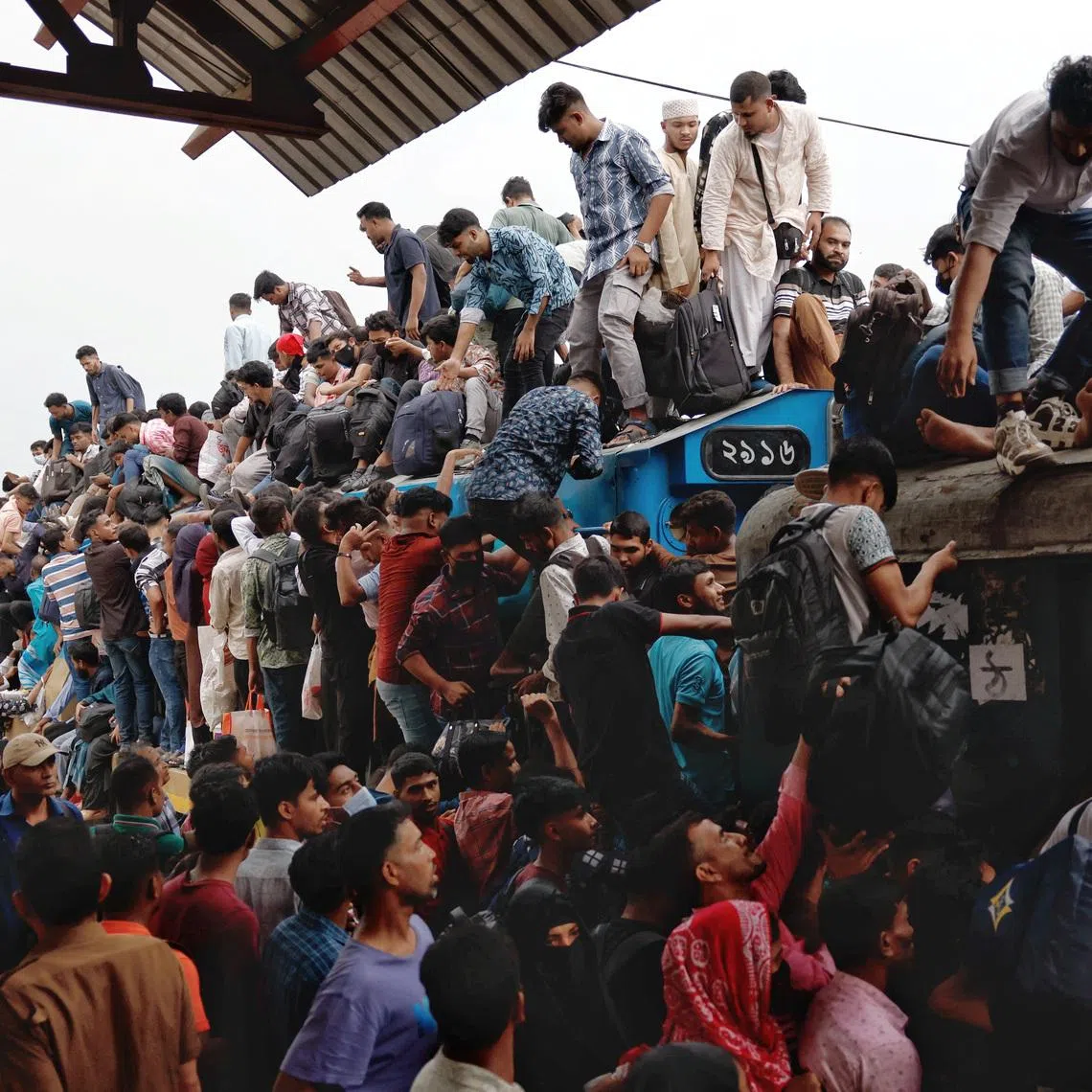 People climbing on top of a train as they leave Dhaka to celebrate Eid al-Fitr, which marks the end of the Muslim holy fasting month of Ramadan, at Tongi Railway Station in Gazipur, Bangladesh.