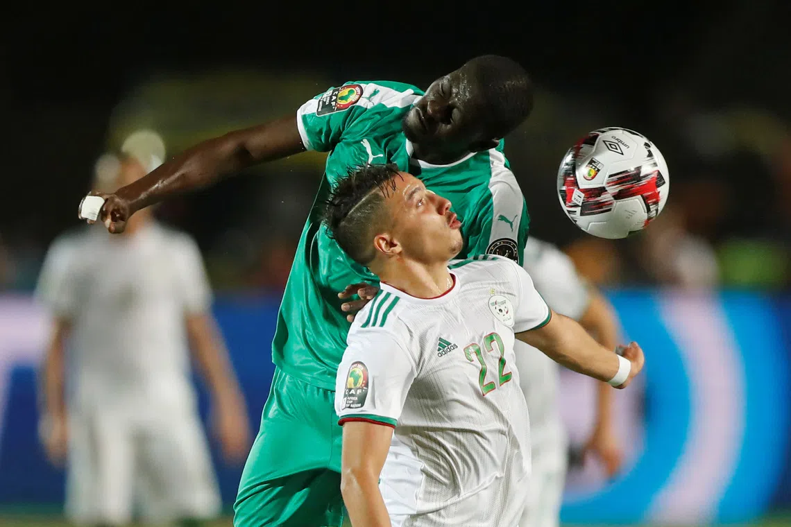 Soccer Football - Africa Cup of Nations 2019 - Final - Senegal v Algeria - Cairo International Stadium, Cairo, Egypt - July 19, 2019    Algeria's Aissa Mandi in action with Senegal's Badou N'Diaye   REUTERS/Amr Abdallah Dalsh/File Photo