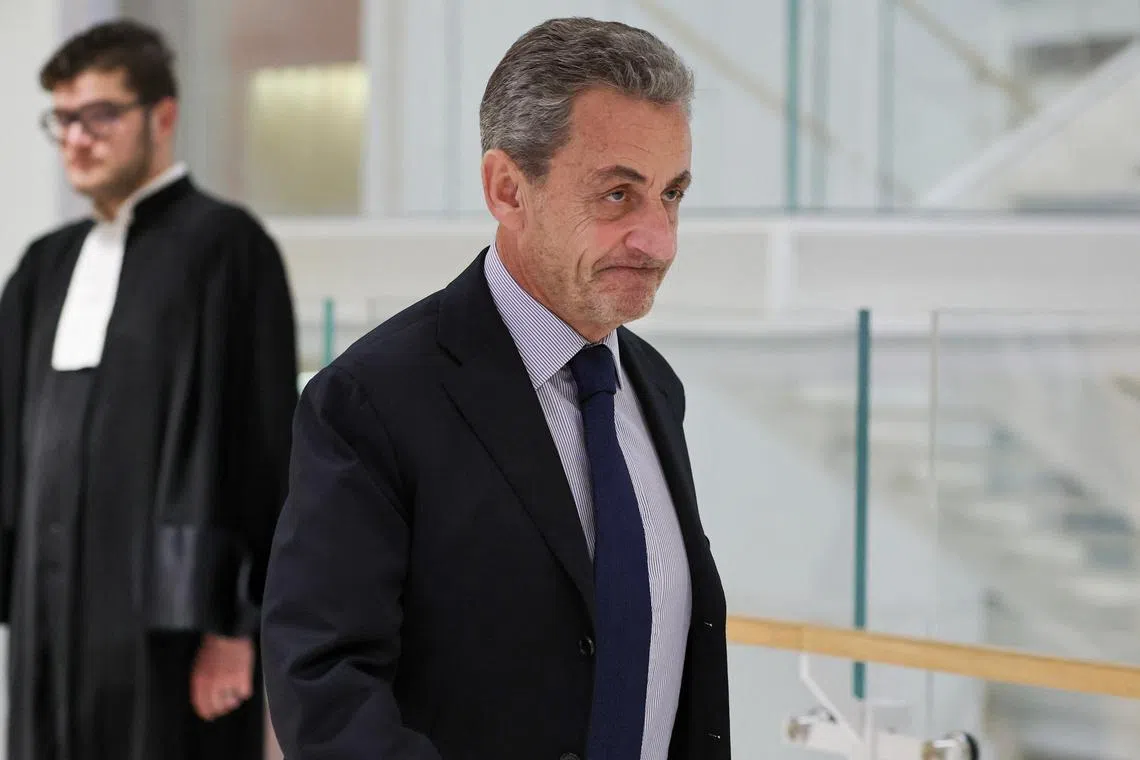 Former French President Nicolas Sarkozy walks, as he attends his trial with twelve other defendants on charges of corruption and illegal financing of an election campaign related to alleged Libyan funding of his successful 2007 presidential bid, at the courthouse in Paris, France, March 27, 2025. REUTERS/Gonzalo Fuentes