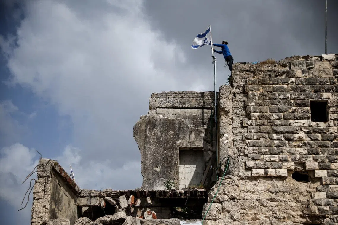 Israeli forces and settlers burn farmland in occupied West Bank