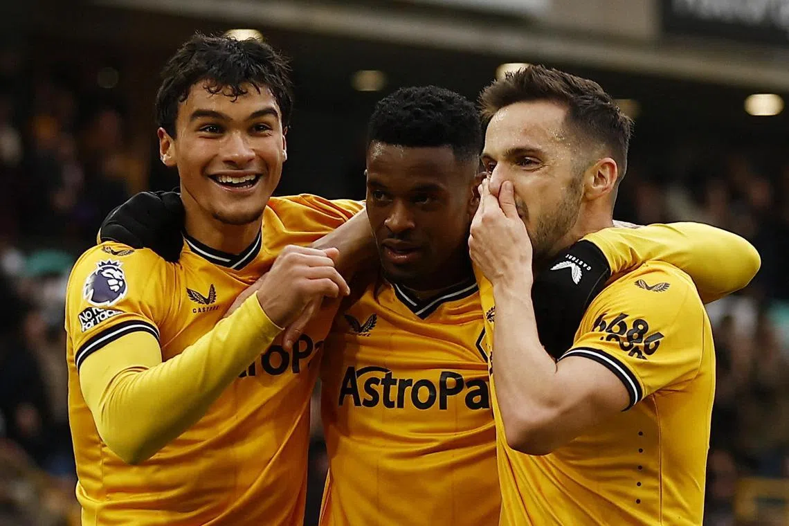 Wolverhampton Wanderers' Nelson Semedo celebrates scoring their second goal - deflected off Fulham's Tom Cairney - with Pablo Sarabia and Nathan Fraser.