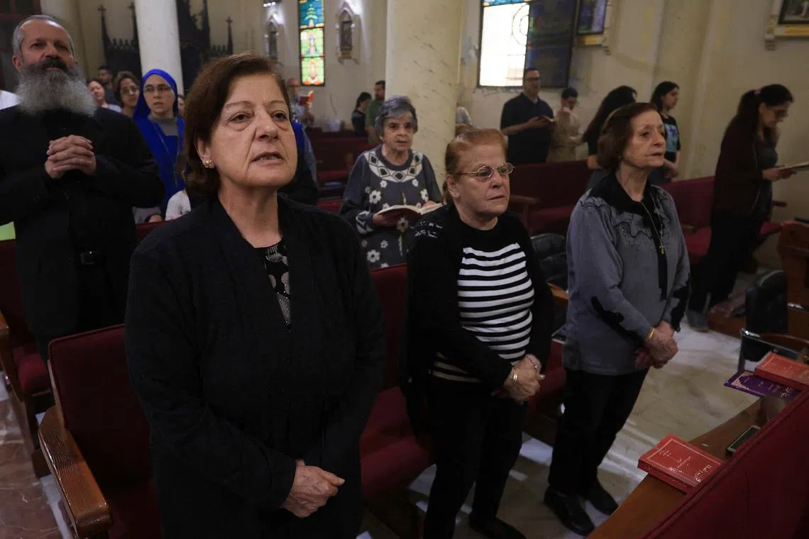 FILE PHOTO: Palestinian Christians attend a Mass at the Holy Family Church after the death of Pope Francis was announced by the Vatican, in Gaza City, April 21, 2025. REUTERS/Dawoud Abu Alkas/File Photo