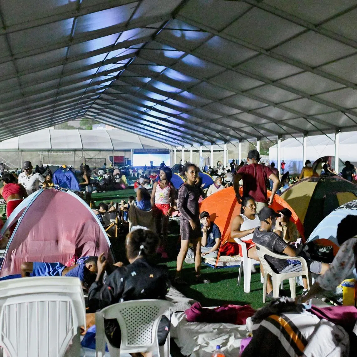 People rest at a temporary shelter in the aftermath of the earthquakes in La Guaira, Venezuela, on June 29.