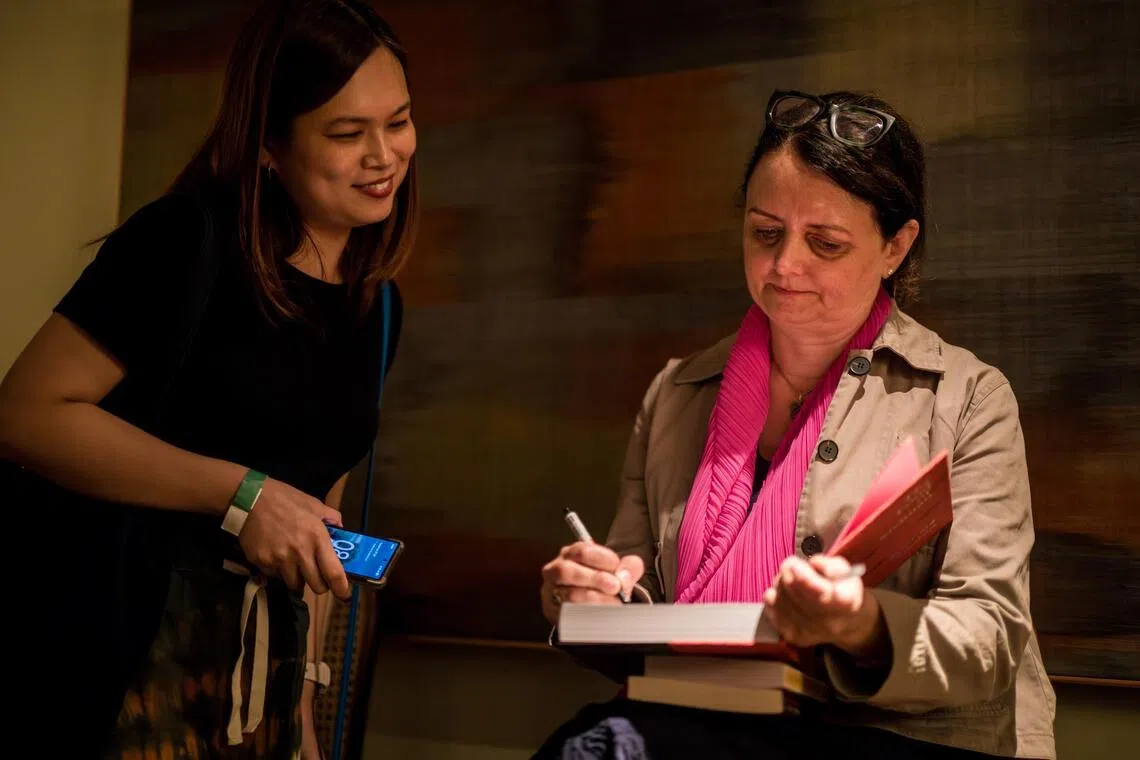 Author Fuchsia Dunlop (right) signing a book for a fan at her Salon session at Belimbing restaurant.