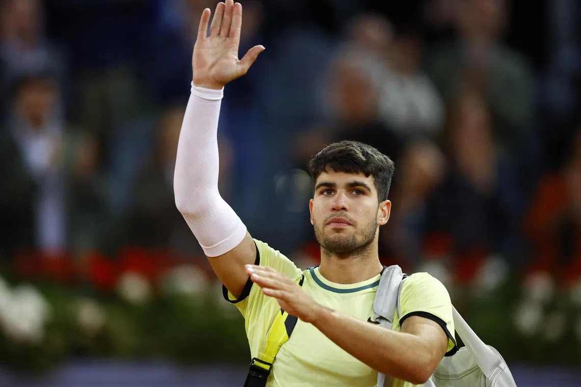 Spain's Carlos Alcaraz bids farewell after his quarter-final match in Madrid.