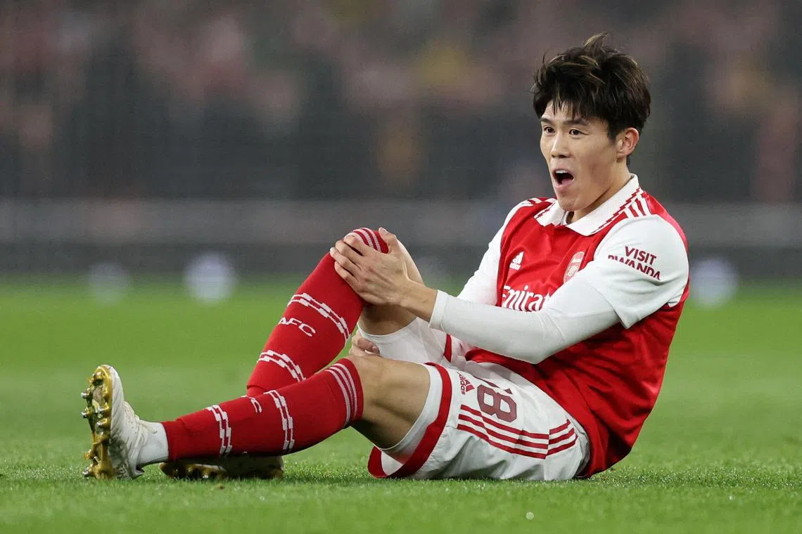 FILE PHOTO: Soccer Football - Europa League - Round of 16 - Second Leg - Arsenal v Sporting CP - Emirates Stadium, London, Britain - March 16, 2023
Arsenal's Takehiro Tomiyasu reacts after sustaining an injury REUTERS/David Klein/File Photo