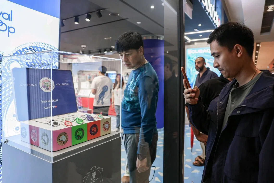 Shoppers looking at the Royal Pop watch collection, a collaboration between Swatch and Audemars Piguet, at the Swatch ION Orchard outlet on May 16, 2026. ST PHOTO: BRIAN TEO