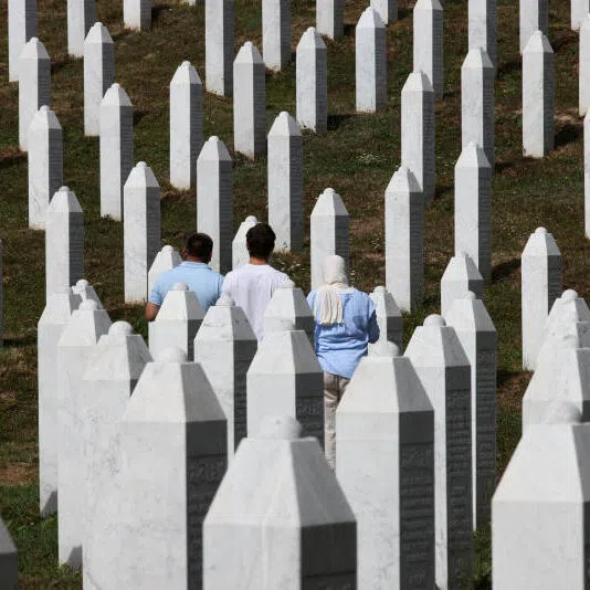 People visiting the cemetery in Potocari, where the victims of the 1995 Srebrenica massacre are buried.