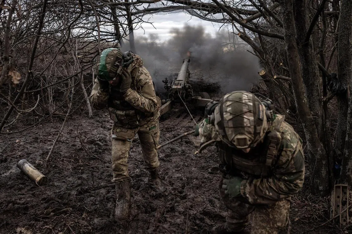 Members of a Ukrainian artillery crew fire towards Russian positions in Ukraine's Donetsk region.