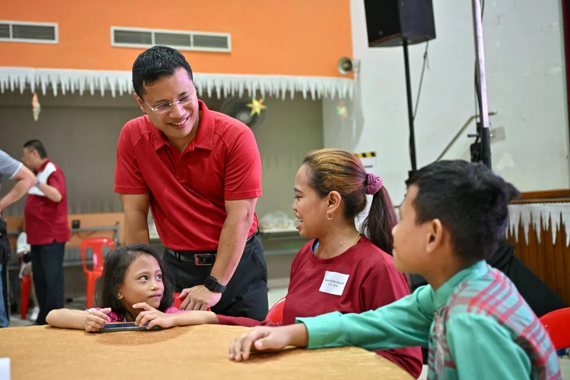 Minister for National Development Desmond Lee (standing) at the launch ceremony of Gift-A-Family at Boon Lay Community Club on Dec 1.