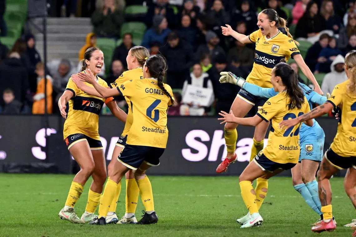 Central Coast Mariners' Bianca Galic (left) celebrates with teammates after scoring the winning penalty in the women's A-League football grand final shoot-out against Melbourne Victory at the Rectangular Stadium in Melbourne on May 18, 2025.
