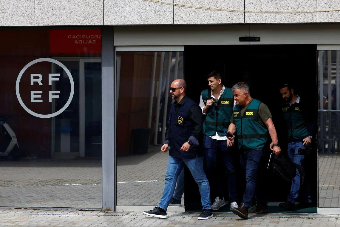 Three Spanish Civil Guards and one Europol officer walk out of the soccer federation headquarters as they search evidence in corruption probe, in Las Rozas, Spain March 20, 2024. REUTERS/Susana Vera